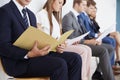 Candidates waiting for job interviews, mid section Royalty Free Stock Photo