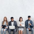 Candidates waiting for job interviews, sitting in row Royalty Free Stock Photo