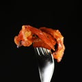 Candied bacon on fork