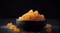 Candied ginger in black bowl, against dark background, Generative AI, AI generated