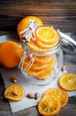 Candied oranges in jar, cinnamon and almond