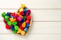 Candies in colorful wrappers on beige wooden table, top view. Space for text Royalty Free Stock Photo