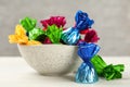 Candies in colorful wrappers on white wooden table, closeup Royalty Free Stock Photo
