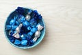 Candies in colorful wrappers on white wooden table, top view. Space for text Royalty Free Stock Photo