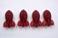 Candies, interesting rubber sweets in the form of red, cherry space rockets located on a white background.