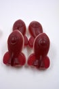 Candies, interesting rubber sweets in the form of red, cherry space rockets located on a white background.