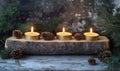 Candle Arrangement on Rustic Log with Pine Cones and Greenery for Cozy Atmosphere Royalty Free Stock Photo