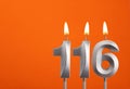 116 candle - Birthday celebration on orange background Royalty Free Stock Photo