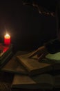 Candle and a book of the Bible on wooden background at night Royalty Free Stock Photo