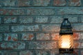 Candle on a brick background with copy space