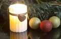 Candle burning and Christmas ornaments Royalty Free Stock Photo