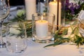 A candle is burning on the festively decorated table Royalty Free Stock Photo