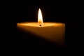 Candle burns at dusk, a candle fire on a black background Royalty Free Stock Photo
