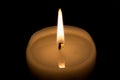 Candle burns at dusk, a candle fire on a black background Royalty Free Stock Photo