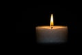 Candle burns at dusk, a candle fire on a black background Royalty Free Stock Photo