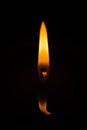 Candle burns at dusk, a candle fire on a black background Royalty Free Stock Photo