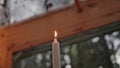 The candle burns on the table in the cafe.