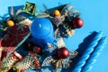 Candle and Christmas decorations on blue background Royalty Free Stock Photo