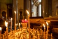 candle church. A row of lighted wax candles in the Christian Orthodox Church on a dark blurred background