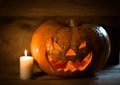 Candle and creepy smiling pumpkin for Halloween