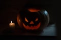 Candle and creepy smiling pumpkin for Halloween