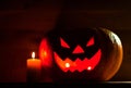 Candle and creepy smiling pumpkin for Halloween