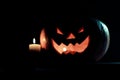 Candle and creepy smiling pumpkin for Halloween