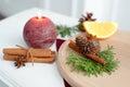 Candle decorated with cinnamon sticks. Christmas table decoration.