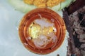 Candle drippings in a gold bowl of water