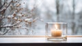 Candle in elegant glass candleholder on a windowsill, with winter landscape seen through the window. Generative AI