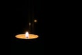 Candle fire burns on a black background of the dark night as the background Royalty Free Stock Photo