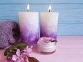 Candle cream cosmetic towel on a wooden background