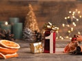 Candle of the first Advent burns, pine cones and Christmas decoration on wood Royalty Free Stock Photo