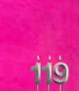 Candle 119 with flame - Birthday card in fuchsia background