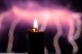 Candle flame on blurred background spark of lightning close-up
