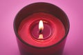 Candle flame close-up. Aromatherapy concept. Romantic atmosphere. Burning red candle on a pink background Royalty Free Stock Photo