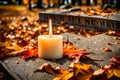Candle flame on a gravestone covered with brittle autumn leaves. November 1st is All Saints Day Royalty Free Stock Photo