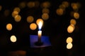 Candle flame at night with bokeh on dark background with go light Blessed is the light of holiness and miracles. Royalty Free Stock Photo