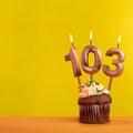 Number 103 birthday candle - Celebration on yellow background