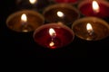 Candle flames in the dark. Candles burn with yellow fire. Royalty Free Stock Photo