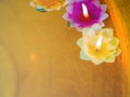 Candle in the flowers colorful holders floating Royalty Free Stock Photo