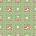 Candle, gift box and, golve with decorative frames on a green background. Cute Christmas seamless pattern for clothing, fabric, Royalty Free Stock Photo