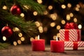 candle and gift boxes on the background of Christmas lights . Royalty Free Stock Photo