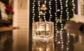 Candle in glass under yellow lighting Royalty Free Stock Photo