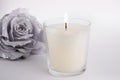 Candle in glass on white background with a rose, product mock-up Royalty Free Stock Photo