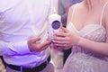 A candle in the hands of the newlyweds. Ignition of the family hearth at the wedding. Royalty Free Stock Photo