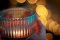 candle in the hands of a woman in a hand on a background of a burning candles Royalty Free Stock Photo