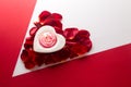 Candle heart on the heart of rose petals corner red white background with space for text Royalty Free Stock Photo