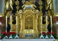 Candle holder with candles, roses and jewellery in front of the gilded and silvered altar of a catholic church in Bavaria Royalty Free Stock Photo