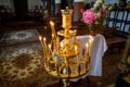 Candle holder with lit candles and flowers inside the church of Sveta Troitsa Holy Trinity in Dryanovo Bulgaria. Royalty Free Stock Photo